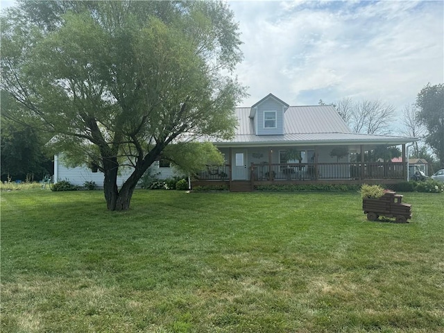 exterior space featuring metal roof, a porch, and a front yard