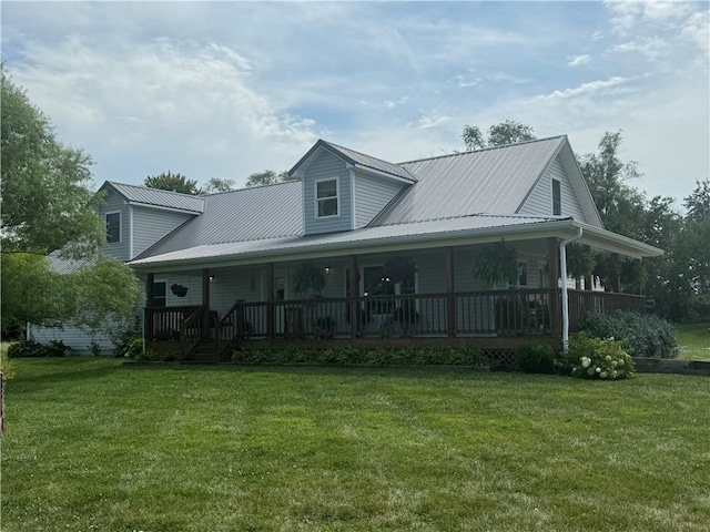 view of front facade featuring covered porch, metal roof, and a front lawn