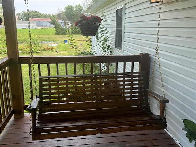 wooden terrace featuring a yard