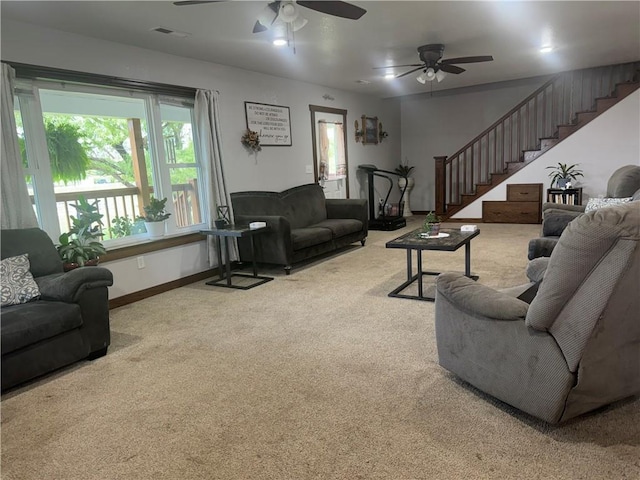 living area with visible vents, stairway, baseboards, and carpet