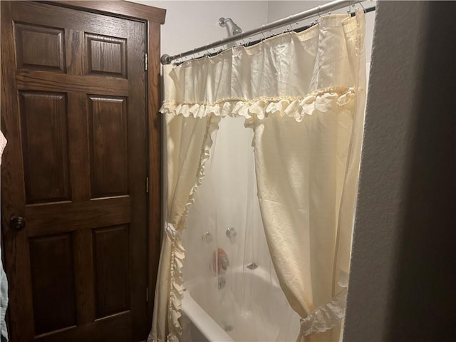 bathroom with shower / tub combo with curtain