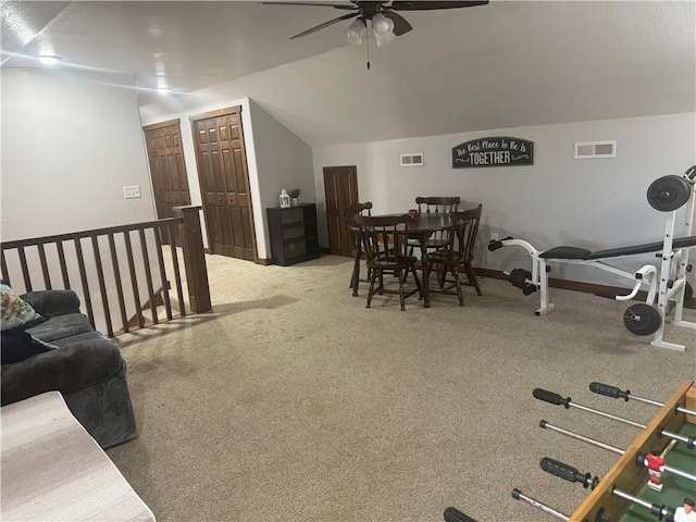 carpeted dining area featuring vaulted ceiling, a ceiling fan, and visible vents