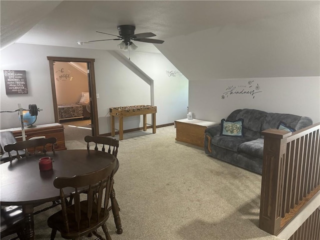 carpeted living room with ceiling fan and vaulted ceiling