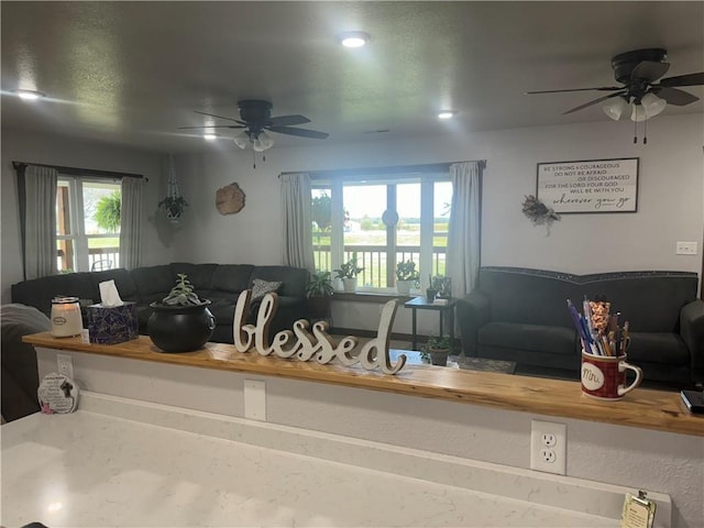 living area featuring ceiling fan