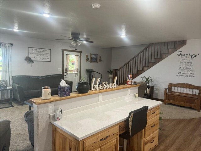 kitchen featuring plenty of natural light, a ceiling fan, light countertops, and open floor plan