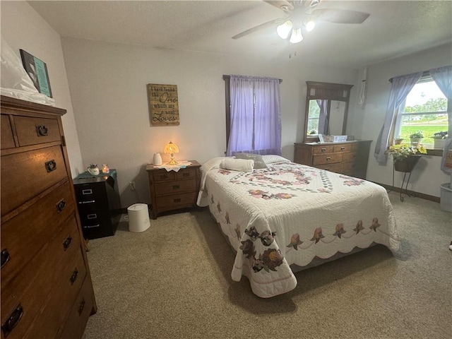 bedroom featuring ceiling fan and light carpet