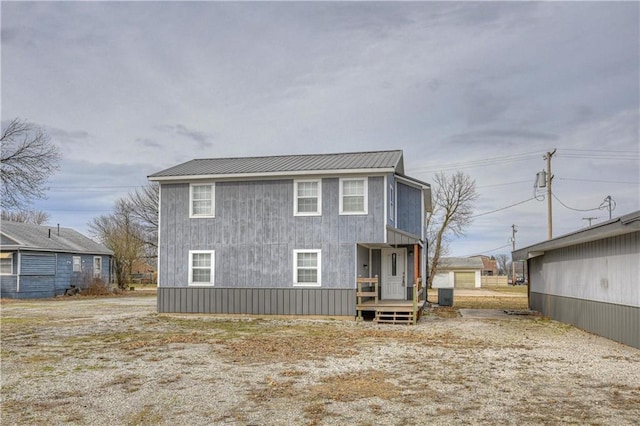 rear view of property featuring metal roof