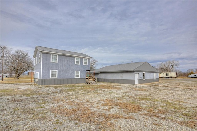 back of house with metal roof