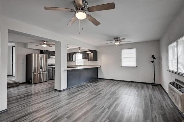 511 N E Ave, Columbus, KS 66725 - kitchen featuring freestanding refrigerator, wood finished floors, light countertops, and a ceiling fan