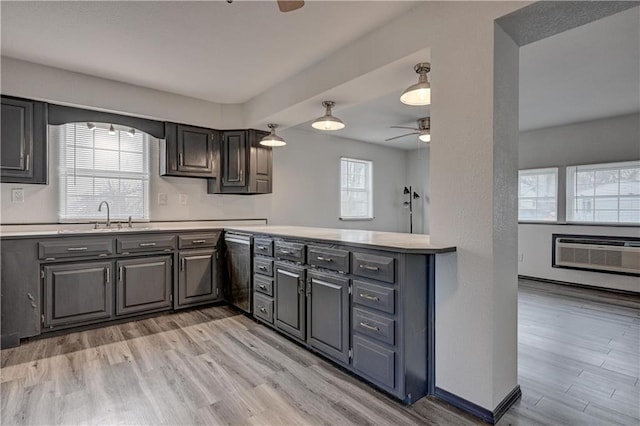 511 N E Ave, Columbus, KS 66725 - kitchen with a ceiling fan, light countertops, light wood-style flooring, and a sink