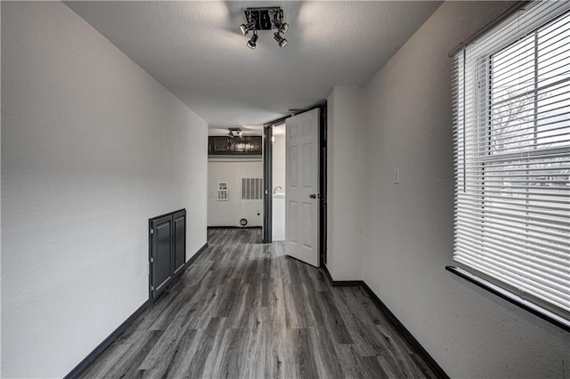 511 N E Ave, Columbus, KS 66725 - hallway with healthy amount of natural light, dark wood-type flooring, and baseboards