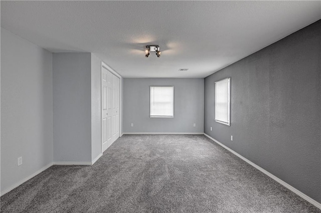 511 N E Ave, Columbus, KS 66725 - unfurnished bedroom featuring carpet floors, baseboards, and a closet