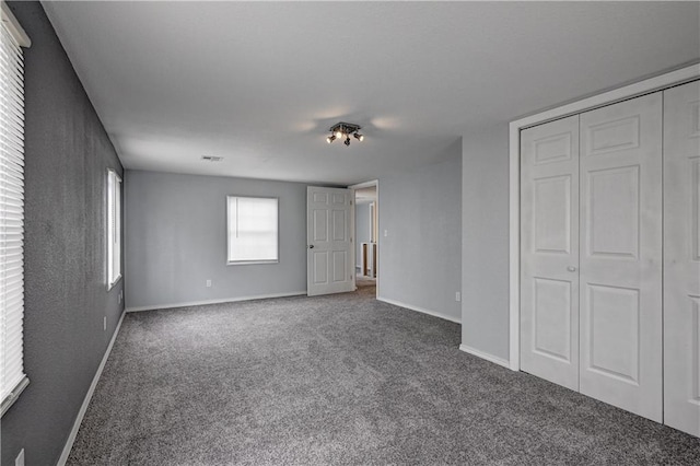 511 N E Ave, Columbus, KS 66725 - unfurnished bedroom featuring carpet flooring, baseboards, and a closet