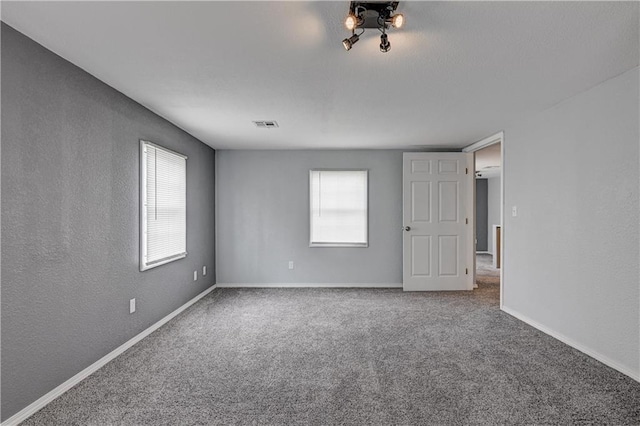 511 N E Ave, Columbus, KS 66725 - spare room with carpet, baseboards, and a textured wall