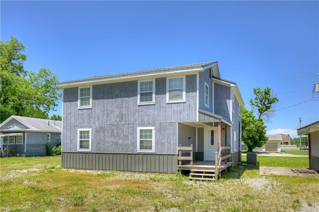 511 N E Ave, Columbus, KS 66725 - back of house with a lawn