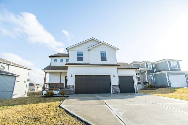 view of front of house featuring driveway, a garage, board and batten siding, and a front yard