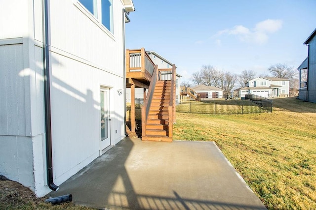 view of yard with stairs, fence, a deck, and a patio