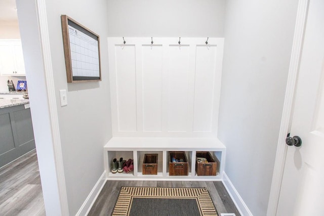 mudroom featuring baseboards and wood finished floors