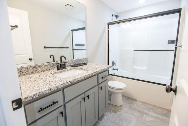 full bath featuring toilet, enclosed tub / shower combo, visible vents, and vanity