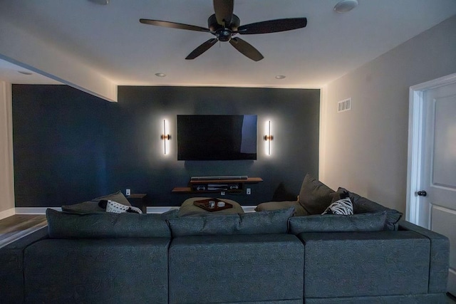 home theater room with visible vents, ceiling fan, and baseboards