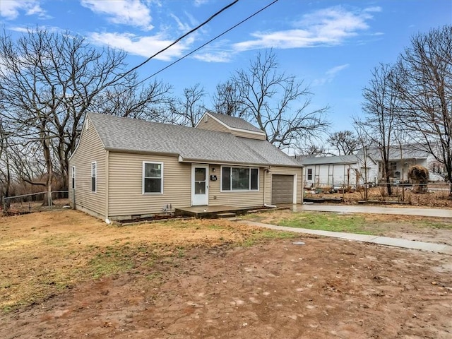 view of front of house with aphalt driveway, roof with shingles, crawl space, fence, and a garage