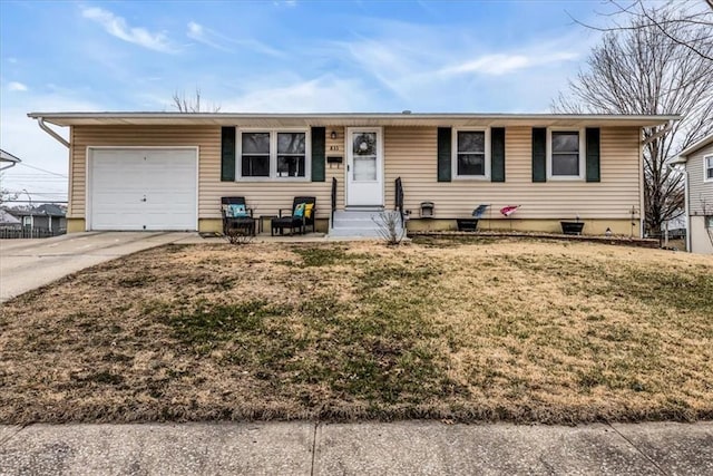 single story home featuring an attached garage, a front lawn, concrete driveway, and entry steps