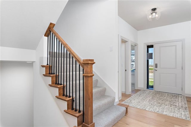 foyer entrance with baseboards and light wood finished floors