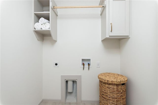 laundry area featuring cabinet space, hookup for a washing machine, electric dryer hookup, and baseboards