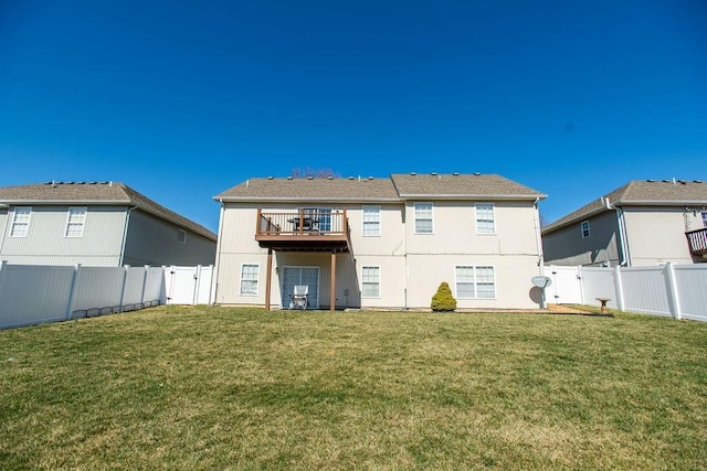 back of house featuring a yard and a fenced backyard