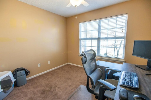 carpeted home office featuring ceiling fan and baseboards