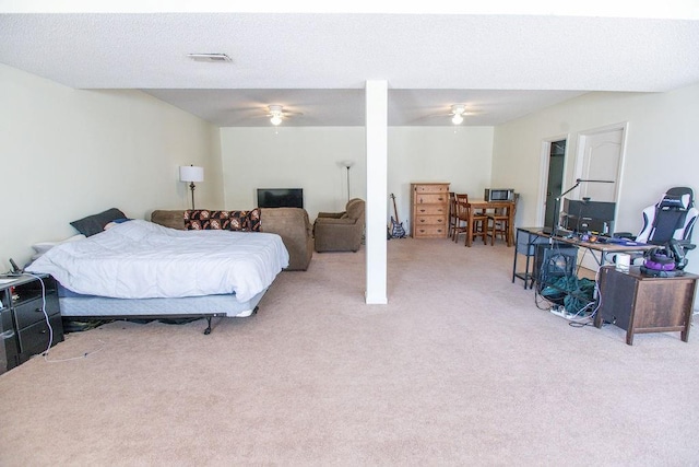 bedroom featuring light carpet, visible vents, and ceiling fan