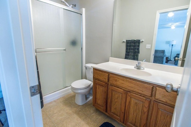 full bath featuring vanity, a shower stall, toilet, and tile patterned flooring