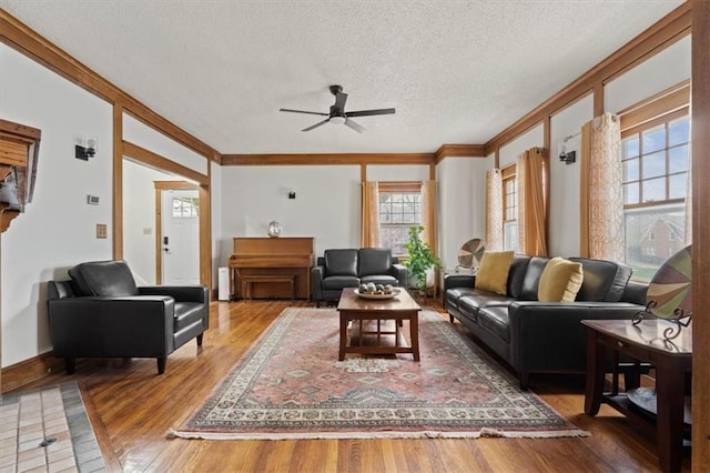 3820 Virginia Ave, Kansas City, MO 64109 - living room with crown molding, a ceiling fan, a textured ceiling, and wood finished floors