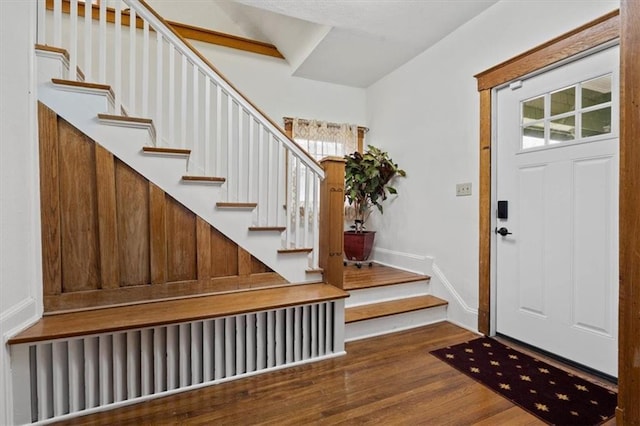 3820 Virginia Ave, Kansas City, MO 64109 - foyer with stairway, baseboards, and wood finished floors