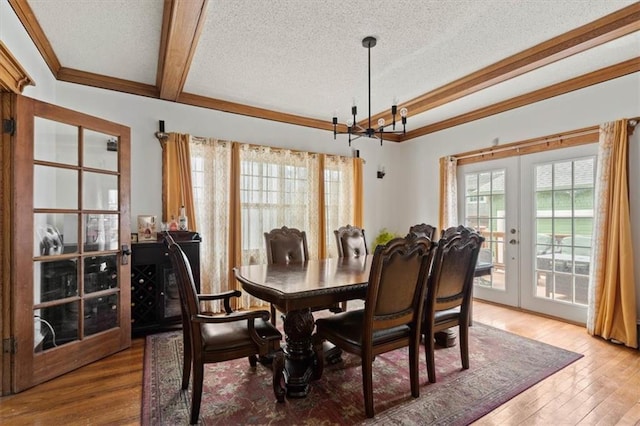 3820 Virginia Ave, Kansas City, MO 64109 - dining area with french doors, a textured ceiling, and plenty of natural light