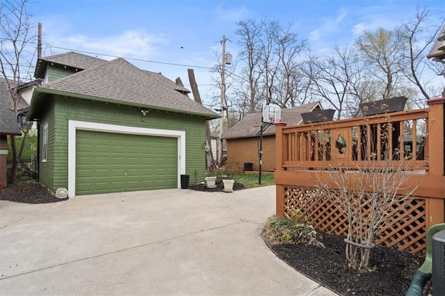 3820 Virginia Ave, Kansas City, MO 64109 - view of property exterior with roof with shingles, a wooden deck, and a garage