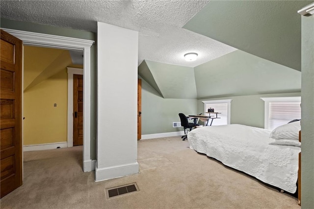 3820 Virginia Ave, Kansas City, MO 64109 - carpeted bedroom featuring a textured ceiling, baseboards, and lofted ceiling