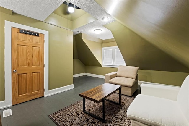 3820 Virginia Ave, Kansas City, MO 64109 - sitting room with a textured ceiling, wood finished floors, baseboards, and lofted ceiling