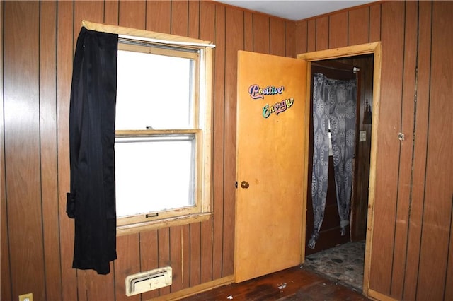 unfurnished room featuring wood walls and visible vents