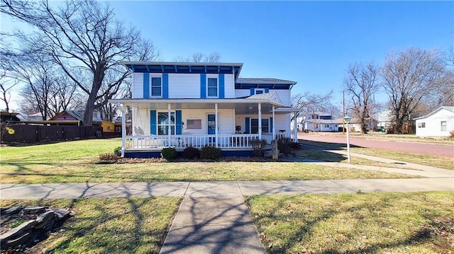 view of front of home featuring a porch, a front yard, and fence