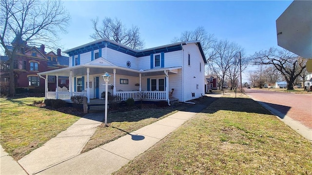 view of front of house with covered porch and a front lawn