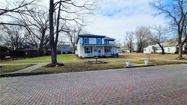 view of front of home with a porch and a front yard