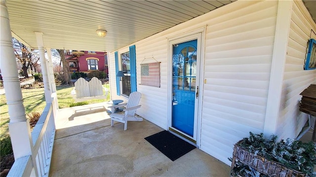 view of exterior entry with a porch