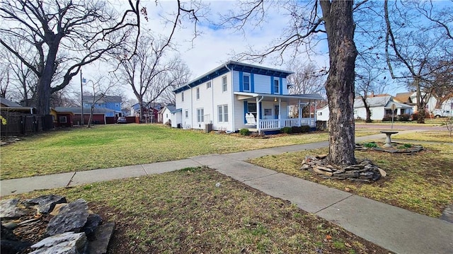 view of front facade featuring a residential view, a porch, and a front lawn