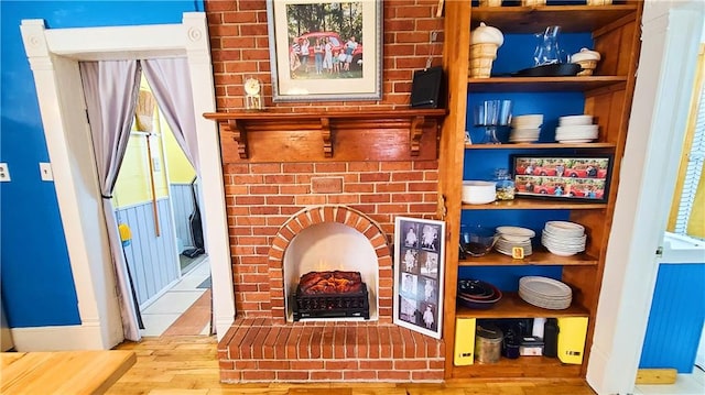 interior details with wood finished floors and a fireplace