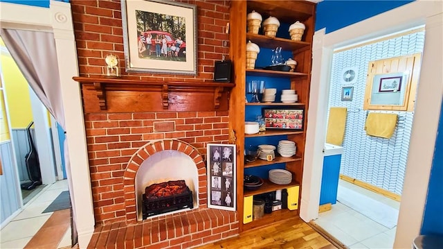 details featuring a fireplace and wood finished floors