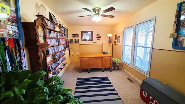 sitting room with a ceiling fan, baseboards, visible vents, and carpet floors