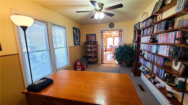 office space with carpet flooring and a ceiling fan