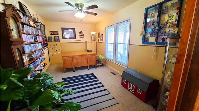 home office with carpet flooring, visible vents, baseboards, and ceiling fan