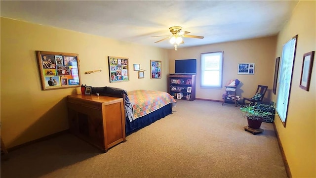 carpeted bedroom with baseboards and ceiling fan